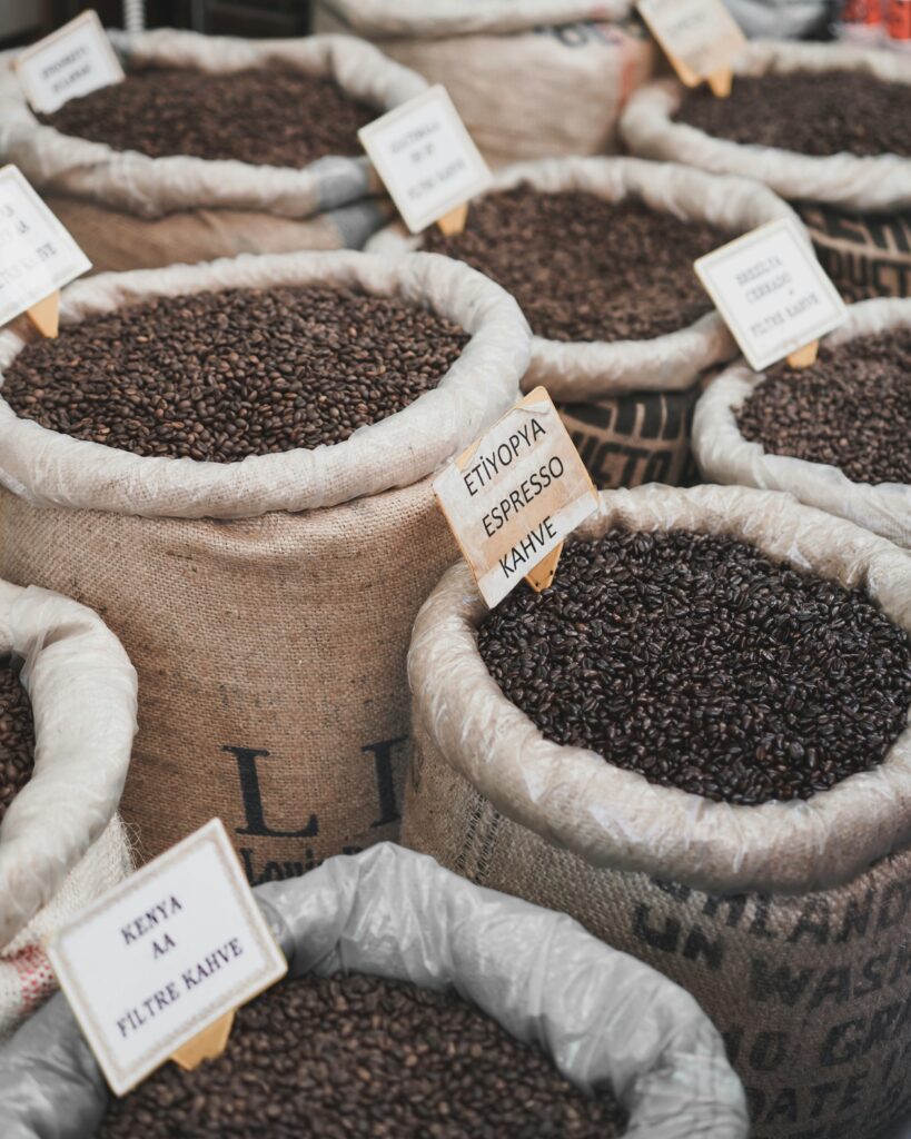 A vibrant display of various coffee beans in sacks at a market in Istanbul.